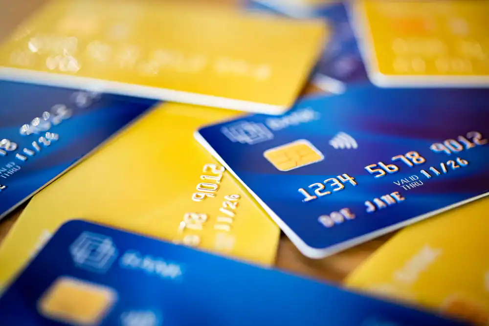 Close-up of blue and gold merchant credit cards, showcasing payment solutions.