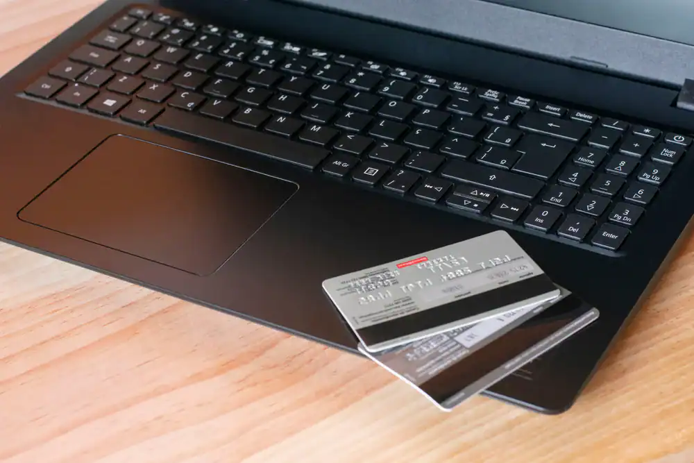 Laptop keyboard with credit card, showcasing secure online payment solutions and merchant services by Merchant Pro Inc.
