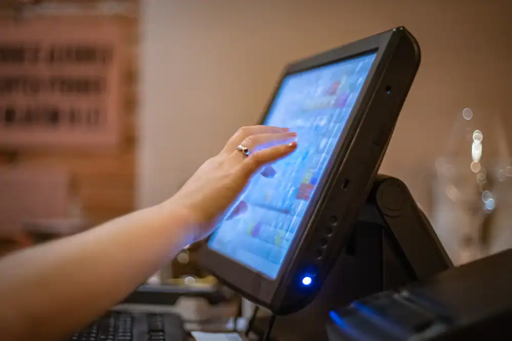 POS touchscreen with user interface for retail and restaurant management.